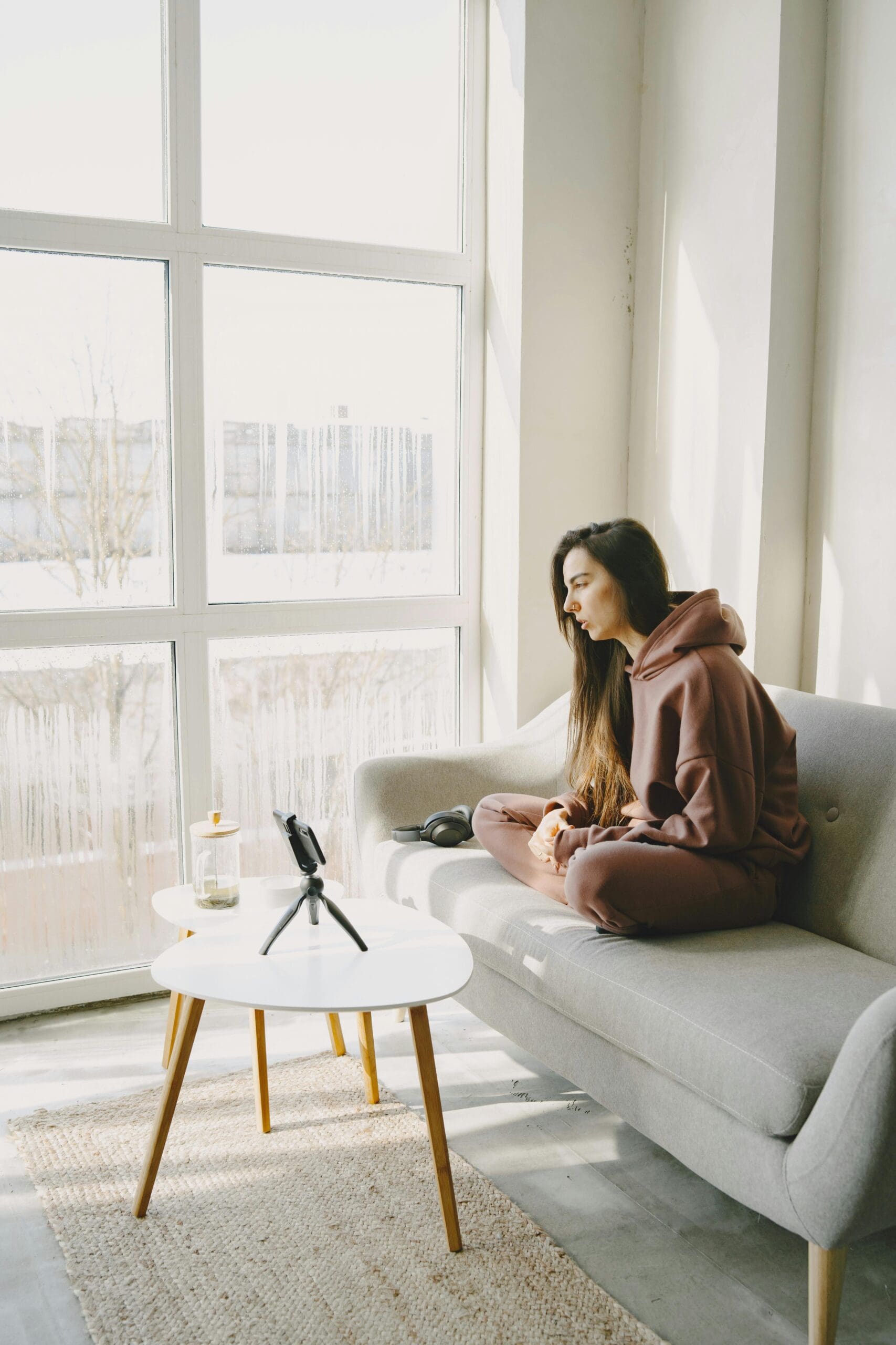 Thoughtful woman sitting on a couch, reflecting on relationship concerns